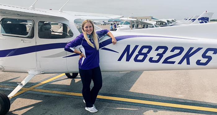 girl next to plane