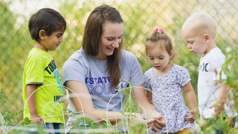 student with children in garden