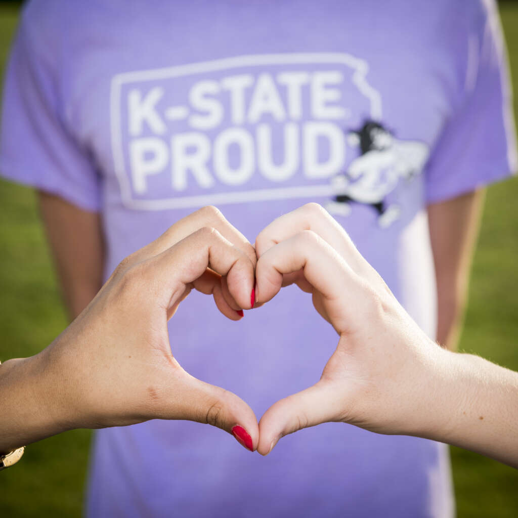 k-state proud t-shirt with hands making a heart shape