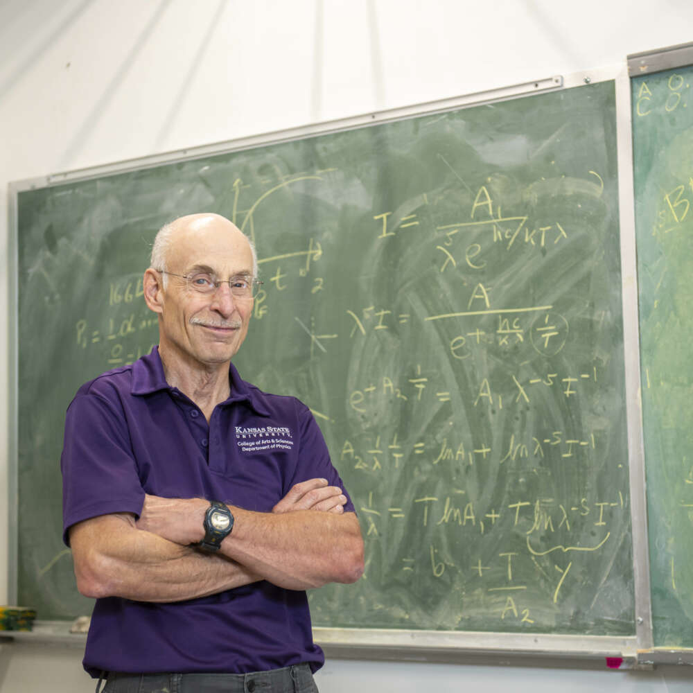 Chris Sorensen standing in front of chalk board