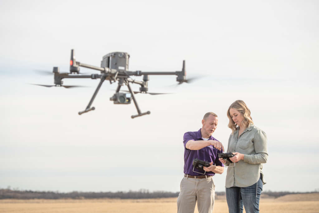 two people operating a drone 