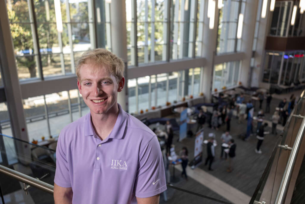 photo of student standing in the college of business 