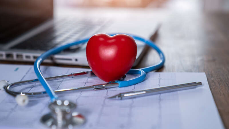 Heart on desk with stethoscope on laptop