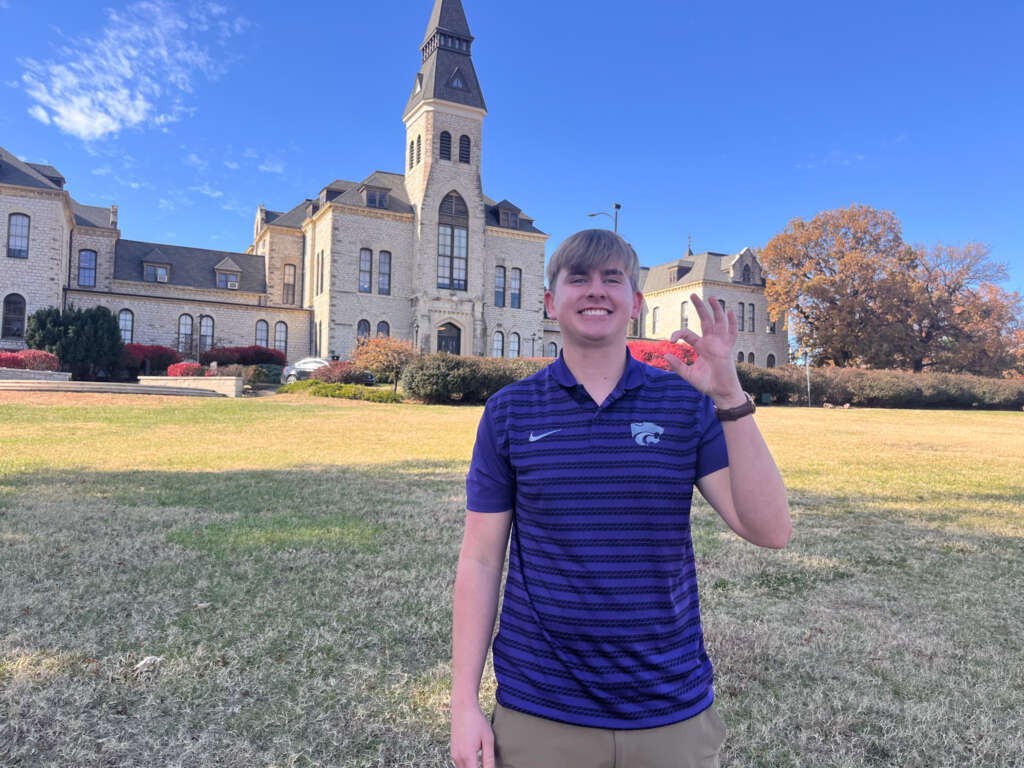 male student standing in front of anderson hall