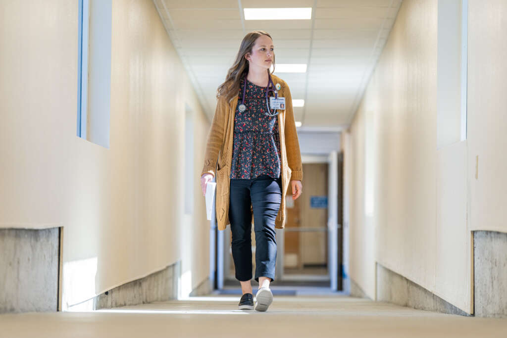 Taylor Niermeier walks in the hallway of Decatur Health in Oberlin, Kansas